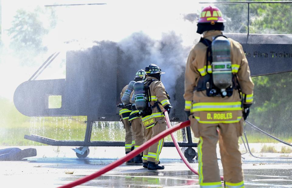 U.S. Air Force firefighters with the 908th Civil Engineer Squadron fully extinguish an internal aircraft fire during a joint interoperability training exercise, August 4, 2022, at Fort Benning, Georgia. This is the first time they were introduced to a helicopter trainer in preparation for the 908th Airlift Wing’s transition to the MH-139A Grey Wolf helicopter training mission.