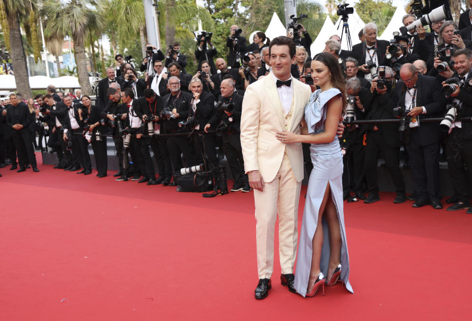 Miles Teller, left, and Keleigh Sperry pose for photographers upon arrival at the premiere of the film 'Top Gun: Maverick' at the 75th international film festival, Cannes, southern France, Wednesday, May 18, 2022. (Photo by Vianney Le Caer/Invision/AP)