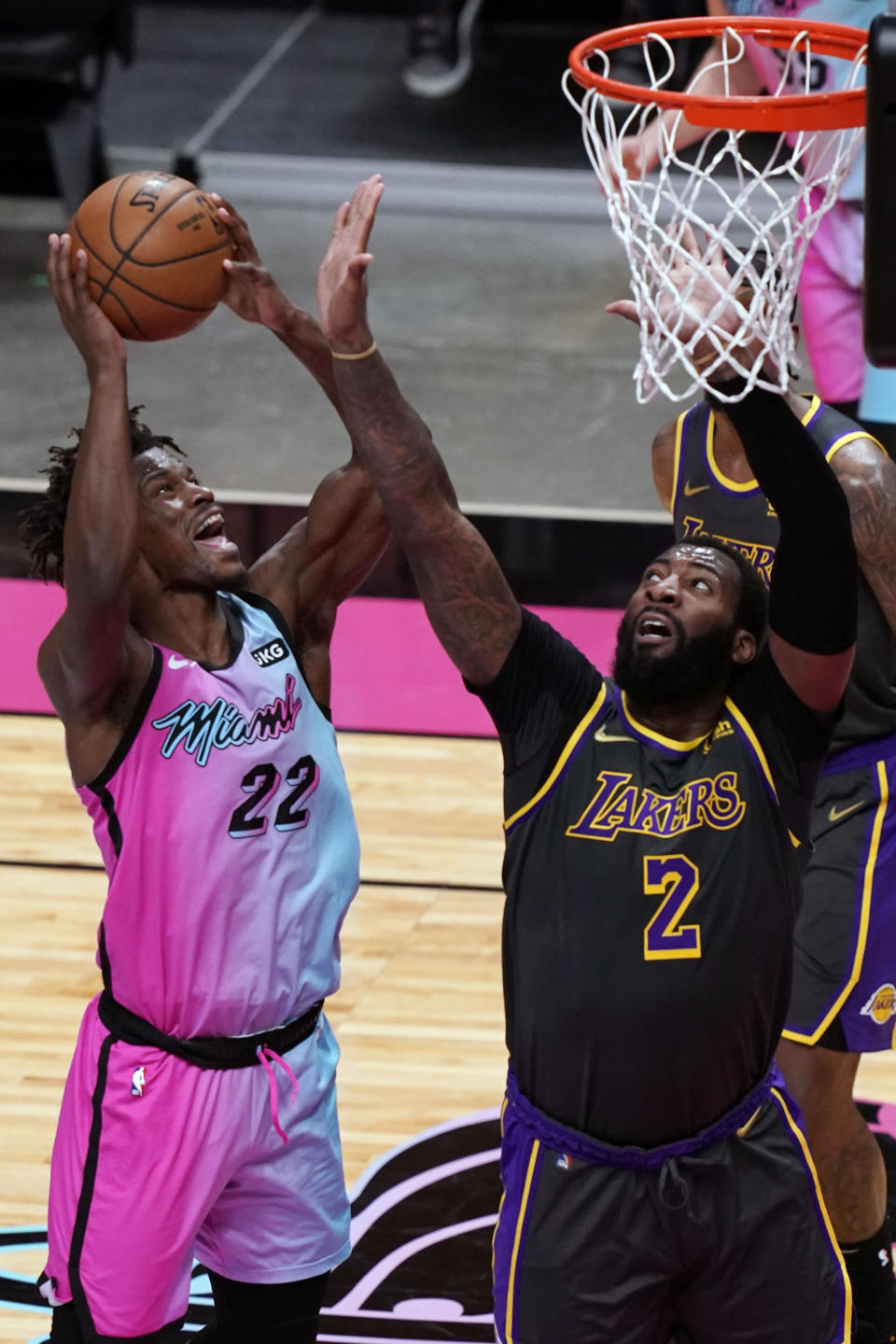 Miami Heat forward Jimmy Butler (22) drives to the basket as Los Angeles Lakers center Andre Drummond (2) defends, during the second half of an NBA basketball game, Thursday, April 8, 2021, in Miami. (AP Photo/Marta Lavandier)