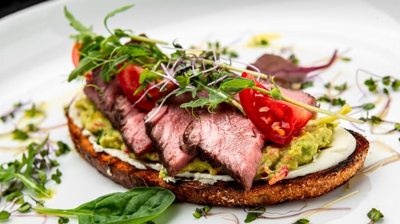 Steak slices with guacacmole and cream cheese with microgreens