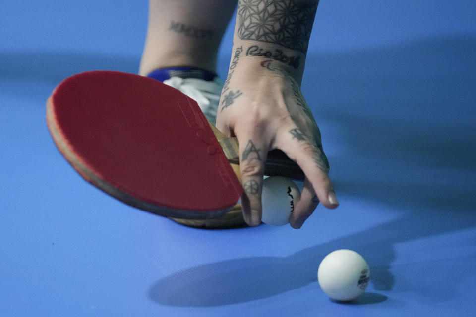 Brazil's Bruna Alexandre grabs for a table tennis ball as she trains during the Pan American Games in Santiago, Chile, Sunday, Oct. 29, 2023. Alexandre is a top five Paralympic table tennis players in the world, but nearing the 220th place in the Olympic rankings, which she started taking part of in January. She hopes to be among the 80 best to qualify for the Paris Games. (AP Photo/Matias Delacroix)