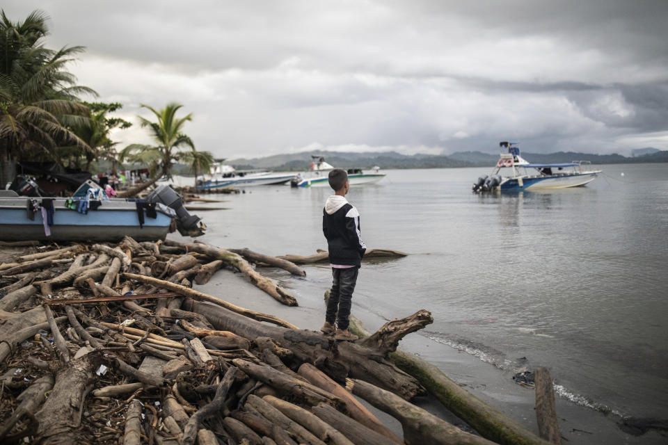 A migrant child observes the sea, in Necocli, Colombia, Saturday, Oct. 7, 2023. New York City Mayor Eric Adams has capped off a four-day trip to Latin America with a visit to the northern Colombian city where thousands of migrants start the perilous trek across the Darien jungle, as they head to the United States. (AP Photo/Ivan Valencia)