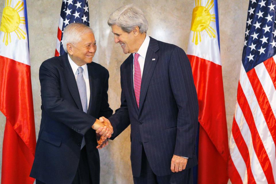 U.S. Secretary of State John Kerry is greeted by Philippines' Foreign Secretary Albert del Rosario for a meeting in Manila