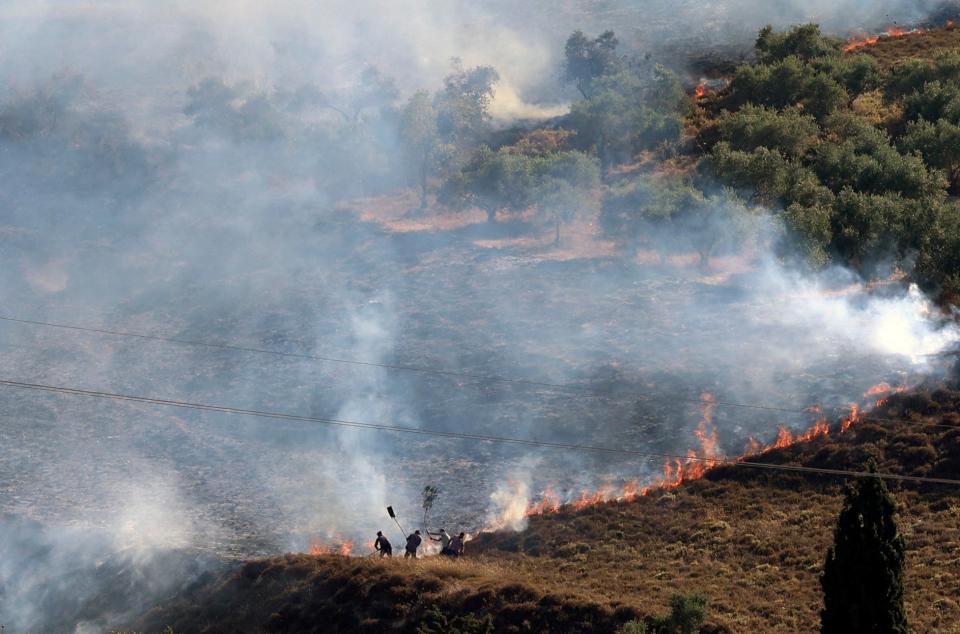 Palestinians extinguish a fire in a field around the village of Burin, south of Nablus in the occupied West Bank after Israeli settlers from the settlement of Yitzhar set it ablaze on 29 June, according to eyewitnesses from the village council (AFP via Getty Images)