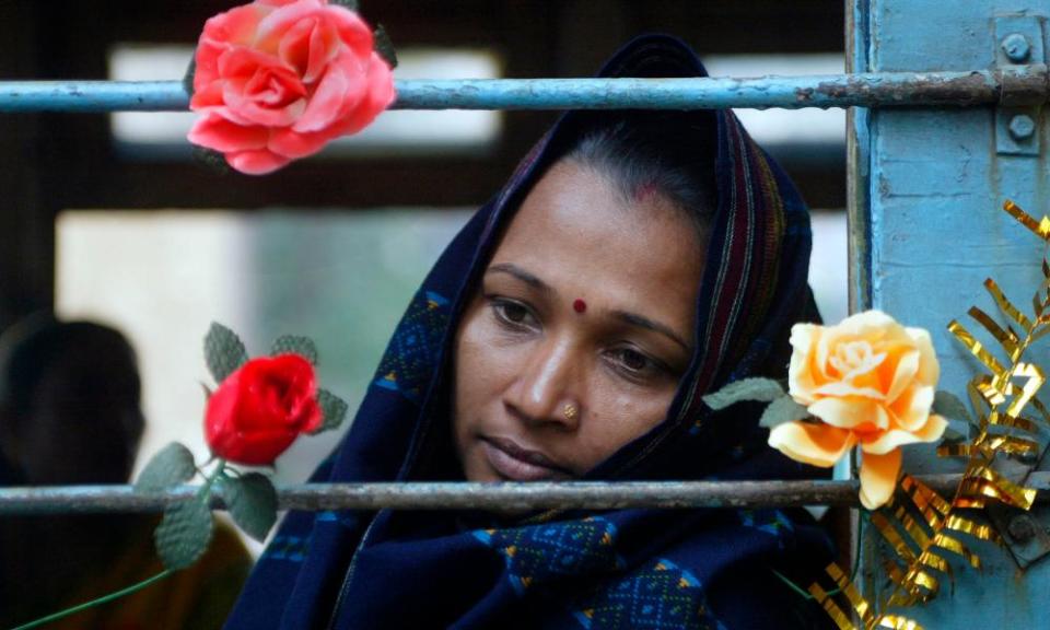 A woman looks out the window of a decorated tram in India which was being used as part of an AIDS prevention awareness campaign