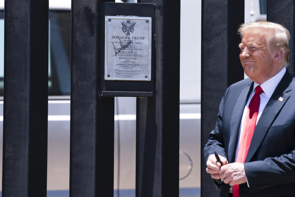 FILE - In this June 23, 2020, file photo President Donald Trump smiles after autographing a section of the border wall during a tour in San Luis, Ariz. Trump and other top Republicans are issuing increasingly urgent calls for the U.S. to seal its borders against a potential mass exodus of Palestinians fleeing war in the Gaza Strip, suggesting that a surge in civilian refugees could allow potential extremists into the country. (AP Photo/Evan Vucci, File)