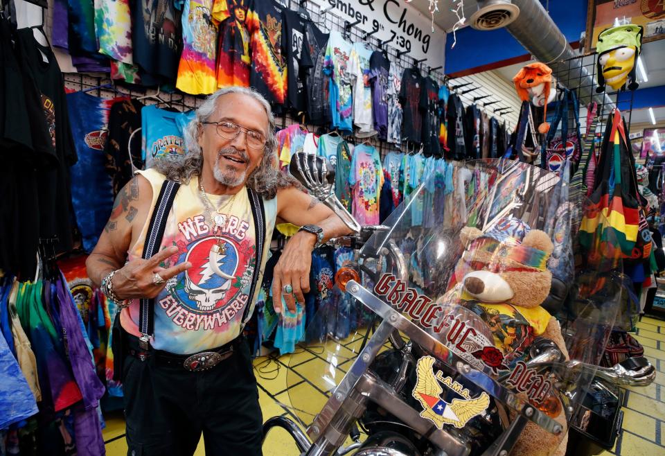 Johnny Sanchez poses with the colorful merchandise in his John's Rock 'N Ride shop on Main Street in Daytona Beach. A presence on Main Street since 1980, Sanchez has made his shop into a shrine for his two greatest passions: Harley-Davidson motorcycles and the Grateful Dead.