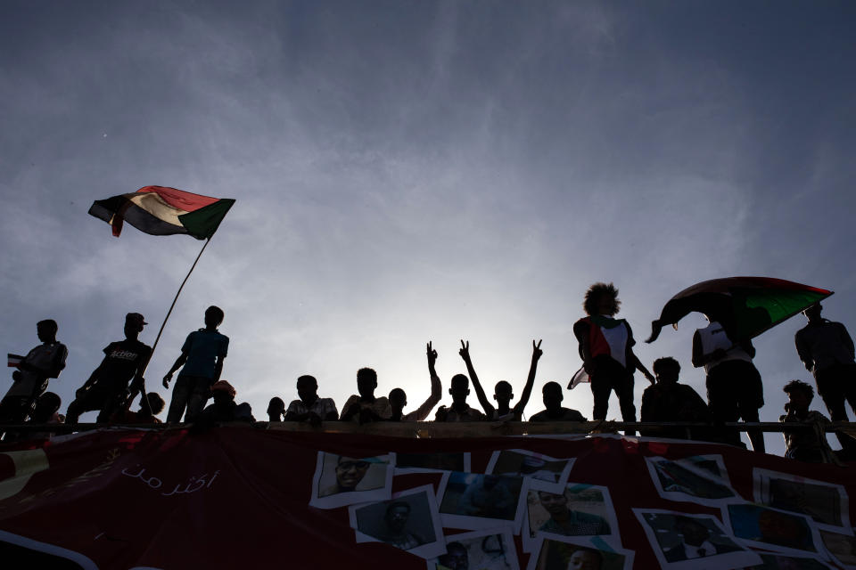 Demonstrators rally near the military headquarters in Khartoum, Sudan, Monday, April 15, 2019. The Sudanese protest movement on Monday welcomed the "positive steps" taken by the ruling military council, which held talks over the weekend with the opposition leaders and released some political prisoners. The praise came despite a brief incident earlier Monday where activists said soldiers attempted to disperse the ongoing protest sit-in outside the military headquarters in the capital, Khartoum, but eventually backed off. (AP Photo/Salih Basheer)