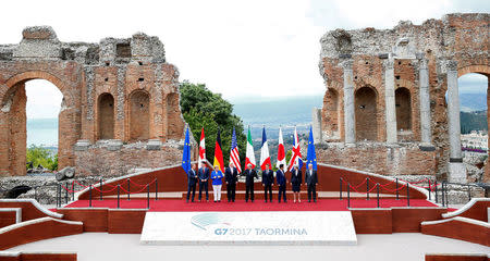 From L-R, European Council President Donald Tusk, Canadian Prime Minister Justin Trudeau, German Chancellor Angela Merkel, U.S. President Donald Trump, Italian Prime Minister Paolo Gentiloni, French President Emmanuel Macron, Japanese Prime Minister Shinzo Abe, Britain’s Prime Minister Theresa May and European Commission President Jean-Claude Juncker pose for a family photo during the G7 Summit in Taormina, Sicily, Italy, May 26, 2017. REUTERS/Tony Gentile