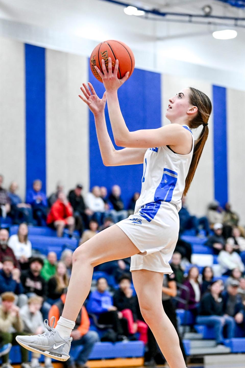 Lansing Community College's Peyton Anderson scores against Mid Michigan College's during the first half on Tuesday, Dec. 19, 2023, in Lansing.