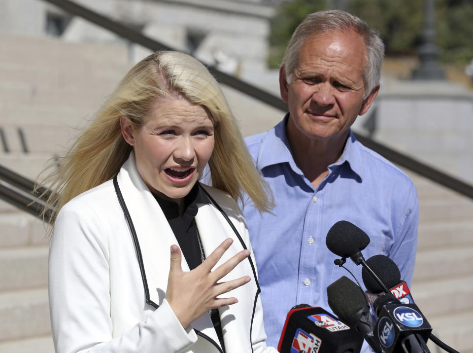 Elizabeth Smart speaks during a news conference while her father Ed Smart looks on Thursday, Sept. 13, 2018, in Salt Lake City. Smart says it appears there is no viable, legal recourse she can take to stop the release of one of her kidnappers. Smart said at a news conference Thursday in Salt Lake City that she only found out about 72-year-old Wanda Barzee's release shortly before the public did. (AP Photo/Rick Bowmer)