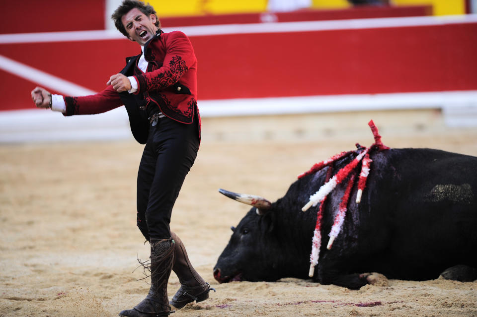 File - In this July 6, 2012 file photo, Spanish mounted bullfighter Pablo Hermoso de Mendoza celebrates beside a dead bull after a horseback bullfight in Pamplona, northern Spain. Spain's state TV will start airing live bullfights again on Sept. 5, 2012 after the new conservative government lifted a six-year ban on the tradition that has been hard hit by declining popularity and the economic crisis. It's a big victory for pro-bullfighting forces who saw fights prohibited this year in the northeastern region of Catalonia. And it's a defeat for animal rights activists who denounce bullfighting as barbaric. The live transmissions were halted in 2006 by Spain's previous Socialist administration, which said they were costly and coincided with youth TV viewing hours. (AP Photo/Alvaro Barrientos, File)