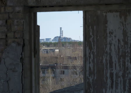 A containment shelter for the damaged fourth reactor at the Chernobyl Nuclear Power Plant is seen from the abandoned town of Pripyat, Ukraine, in this April 23, 2013 file photo. REUTERS/Gleb Garanich/Files