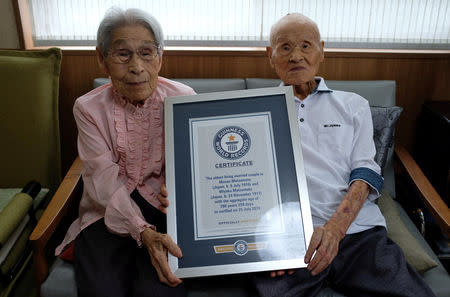 World's oldest living married couple Masao Matsumoto (R) and Miyako Matsumoto poses with the Guinness World Record certificate at a nursing house in Takamatsu, Kagawa prefecture, Japan September 4, 2018. REUTERS/Kwiyeon Ha