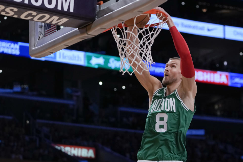 Boston Celtics center Kristaps Porzingis dunks the ball during the first half against the Los Angeles Lakers on Dec. 25, 2023, in Los Angeles. (AP Photo/Ryan Sun)
