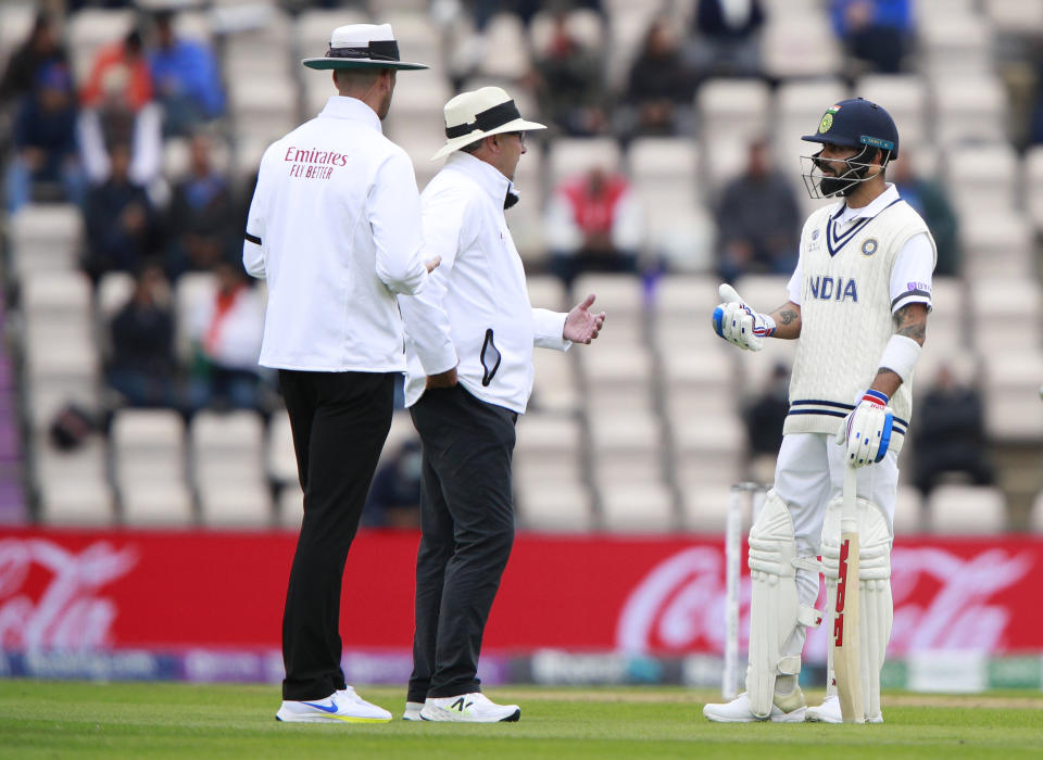 India's captain Virat Kohli, right, interacts with the umpires during the second day of the World Test Championship final cricket match between New Zealand and India, at the Rose Bowl in Southampton, England, Saturday, June 19, 2021. (AP Photo/Ian Walton)