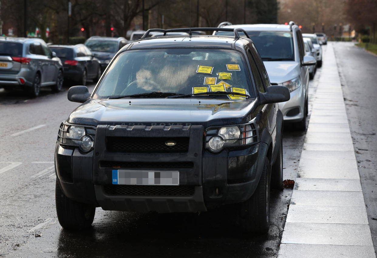 NUMBER PLATE PIXELATED BY THE PA PICTURE DESK Parking Notice fixed penalties are attached to the windscreen of a Land Rover Freelander on South Carriage Drive in Hyde Park, London.