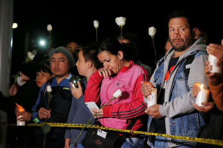 People take part in a candlelight vigil to honor victims, close to the scene of a car bomb explosion, in Bogota, Colombia January 17, 2019. REUTERS/Luisa Gonzalez