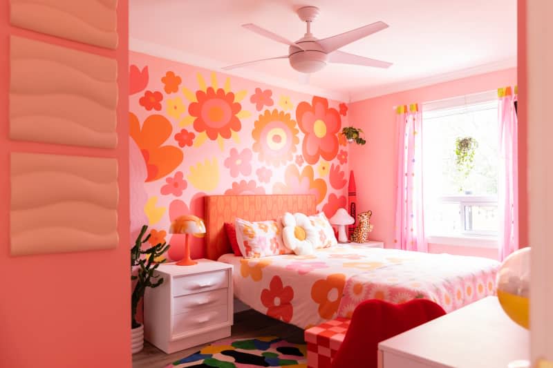Pink, orange and yellow flower motif in vintage inspired colorful bedroom.