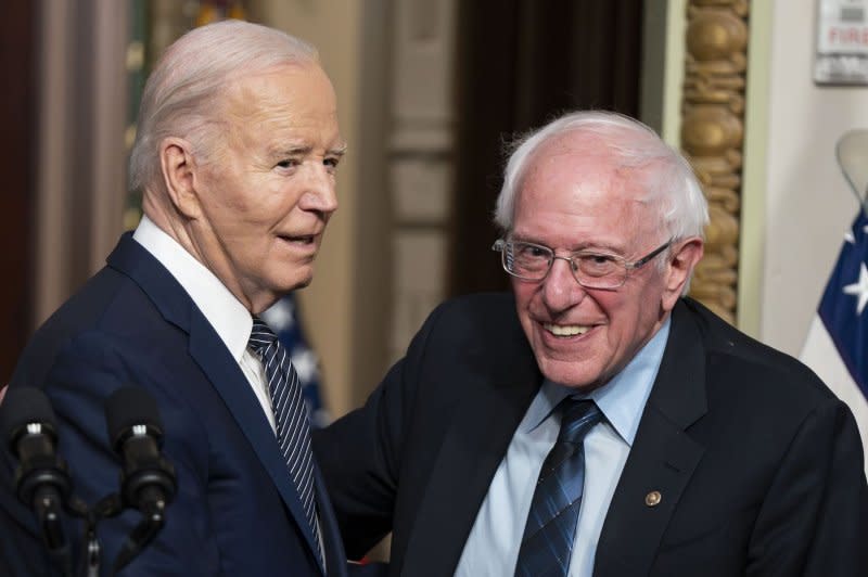 President Joe Biden and Sen. Bernie Sanders, I-Vt., shake hands as they tout their accomplishments to lower "outrageous" prescription drug costs, during an event Wednesday in the Indian Treaty Room on the White House complex in Washington, D.C. Photo by Bonnie Cash/UPI