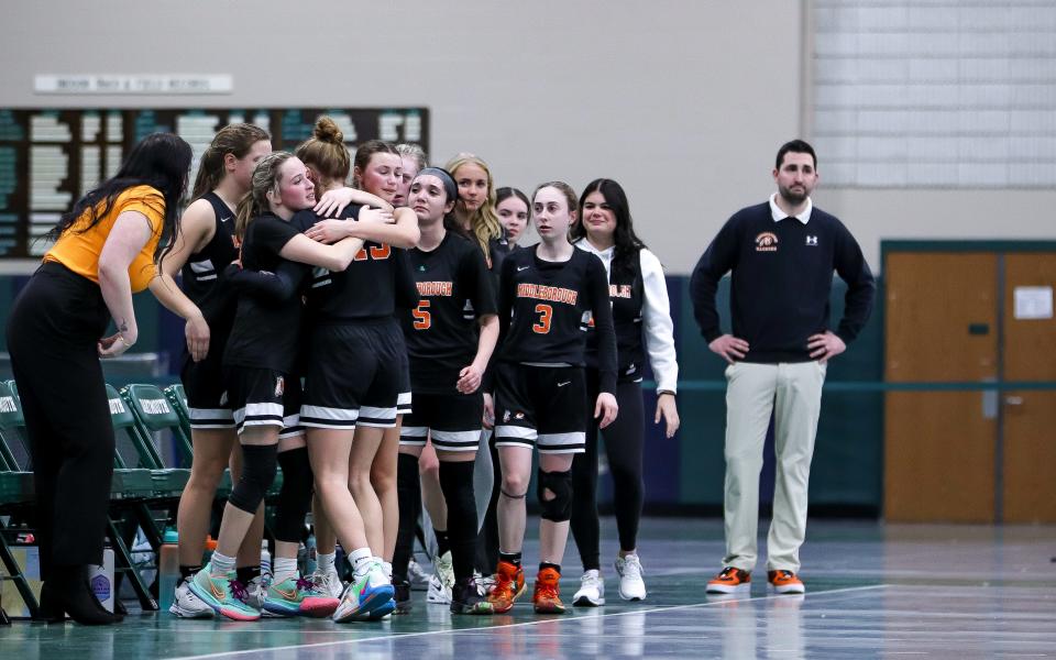 The Middleboro bench hugs the team's lone senior Lila Peddie during a preliminary game against Dartmouth in the Div. 2 state tournament on Monday, Feb. 27, 2023.