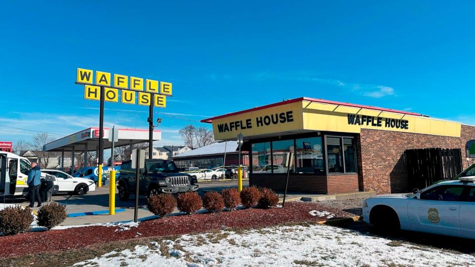 PHOTO: Police cars are shown near a Waffle House in Indianapolis, Feb. 19, 2024, where at least one person was killed and several injured. (Isabella Volmert/AP)