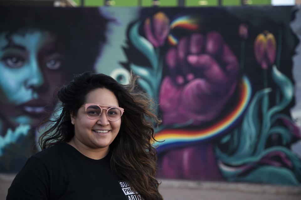Ashley Macias with her portion of the Black lives matter mural "Art is Protest" in downtown Phoenix in April 2021.