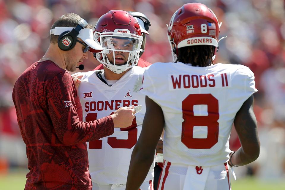 OU coach Lincoln Riley talks with quarterback Caleb Williams (13) during the Sooners' 55-48 win against Texas at the Cotton Bowl in Dallas on Saturday.