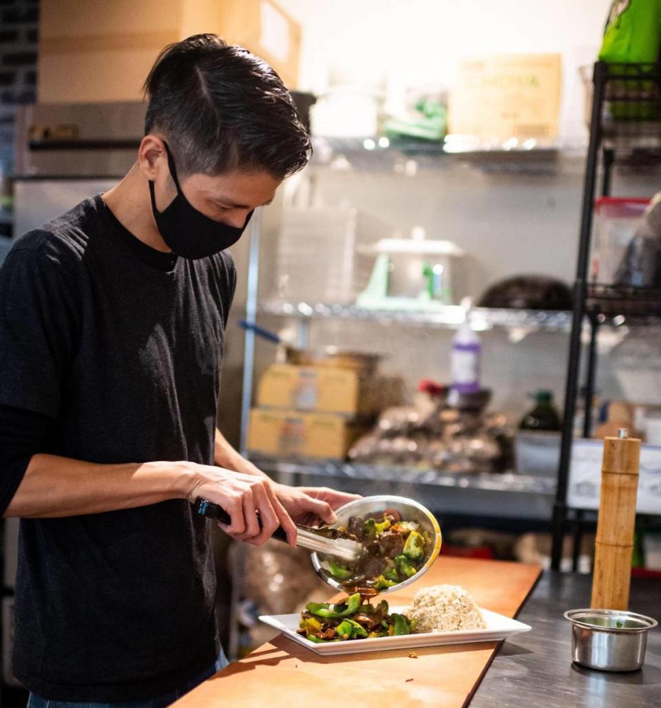 Andy Nguyen, of the namesake Andy Nguyen’s Vegetarian Restaurant, prepares a dish at his Broadway restaurant in 2020. He has a new vegan burger bar in midtown.