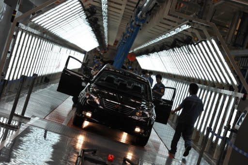 Workers build a car on an assembly line in China's Zhejiang province. China's manufacturing activity contracted at its slowest pace in five months in July, an independent survey showed Tuesday, indicating that Beijing's easing measures were beginning to take effect