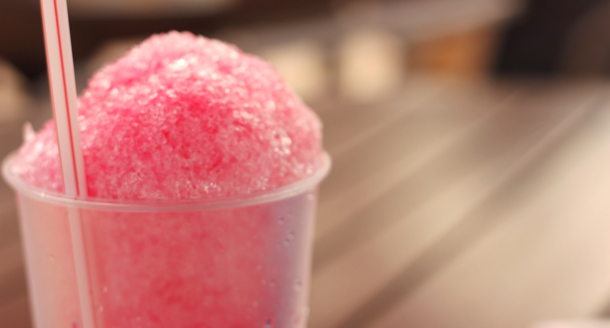 pink slushie in clear cup with straw on blurry background, According to one Amazon reviewer, the Magic Squeeze cup 