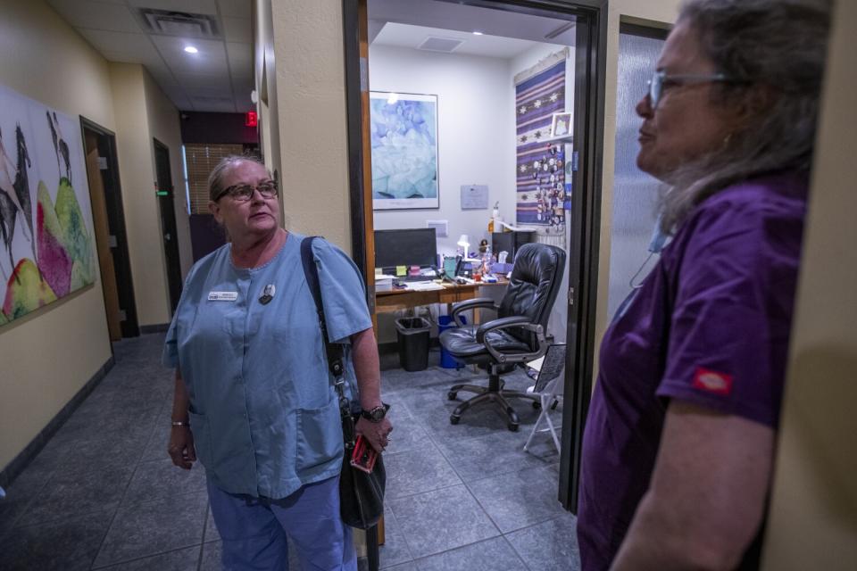 Two women talking in a hallway