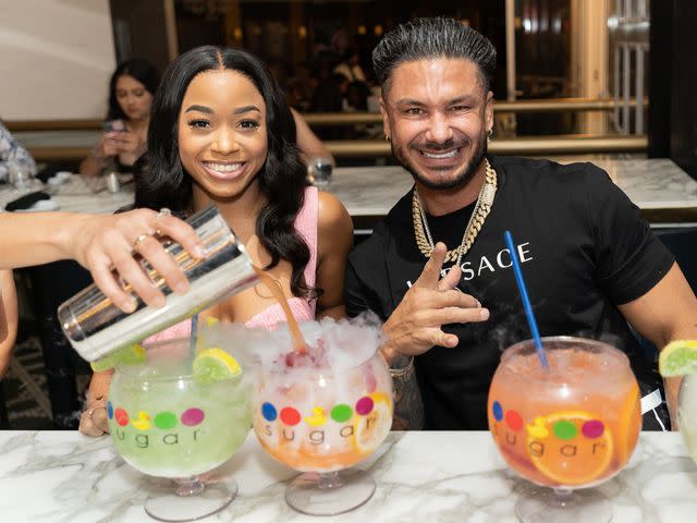 <p>MediaPunch/Shutterstock </p> Nikki Hall and DJ Pauly D celebrating the grand opening of Sugar Factory's new location in Las Vegas