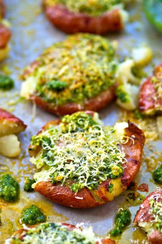 <p>Whole and Heavenly Oven</p><p>Crispy smashed red potatoes are drizzled in a flavorful basil pesto and topped with lots of Parmesan cheese for an easy and addicting side dish!</p><p><strong>Get the recipe: <a href="https://wholeandheavenlyoven.com/2018/01/17/parmesan-basil-pesto-smashed-red-potatoes/" rel="nofollow noopener" target="_blank" data-ylk="slk:Parmesan Basil Pesto Smashed Red Potatoes;elm:context_link;itc:0;sec:content-canvas" class="link ">Parmesan Basil Pesto Smashed Red Potatoes</a></strong></p>