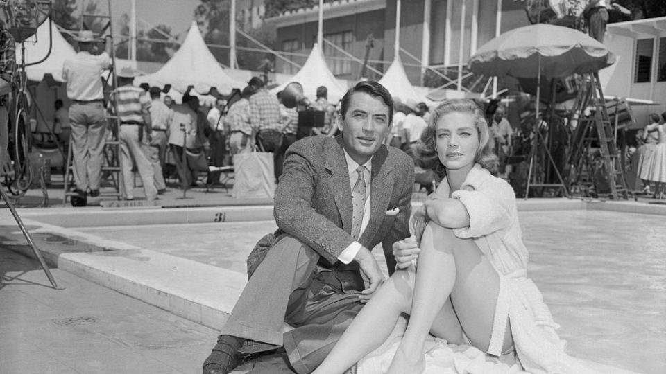 Gregory Peck and Lauren Bacall Sitting by Pool