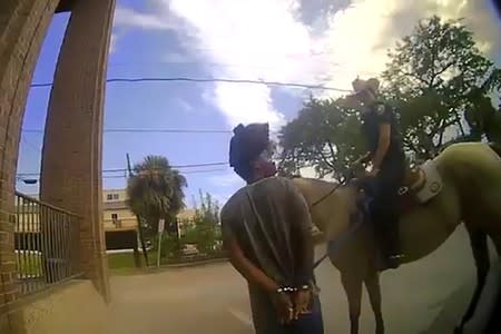 Galveston police officer Amanda Smith leads Donald Neely on horseback in Galveston