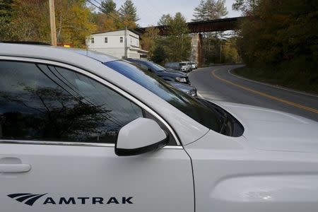 Amtrak officials are parked at the train trestle over the road near where an Amtrak passenger train derailed in Northfield, Vermont October 5, 2015. REUTERS/Brian Snyder