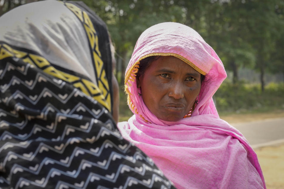 Asiya Khatoon, right, who had travelled nearly 31 kilometers (19 miles) from her home to meet her husband Abul Kalam, stands outside a detention center where he has been held since January in Matiya village, northeastern Assam state, India, April 17, 2023. They (police) just came and picked up my husband saying he is a Bangladeshi,” the 45-year-old said before hurriedly walking toward the center circled by a vast perimeter of walls and watchtowers with security cameras and armed guards. (AP Photo/Anupam Nath)