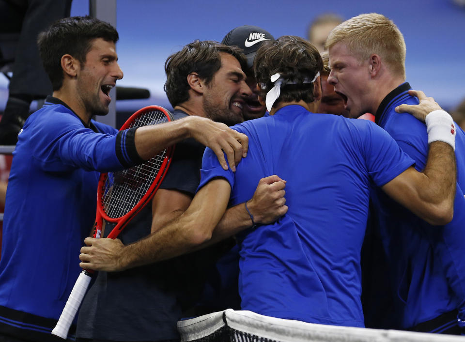 From left to right, Team Europe's Novak Djokovic, Jeremy Chardy, Roger Federer and Kyle Edmund celebrate a men's singles tennis match win against Team World's John Isner at the Laver Cup, Sunday, Sept. 23, 2018, in Chicago. (AP Photo/Jim Young)