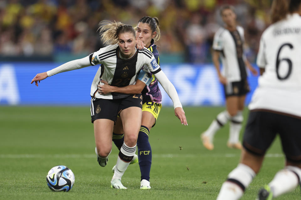 Colombia's Daniela Montoya holds back Germany's Sara Doorsoun, left, during the Women's World Cup Group H soccer match between Germany and Colombia at Sydney Football Stadium in Sydney, Australia, Friday, July 28, 2023. (AP Photo/Sophie Ralph)