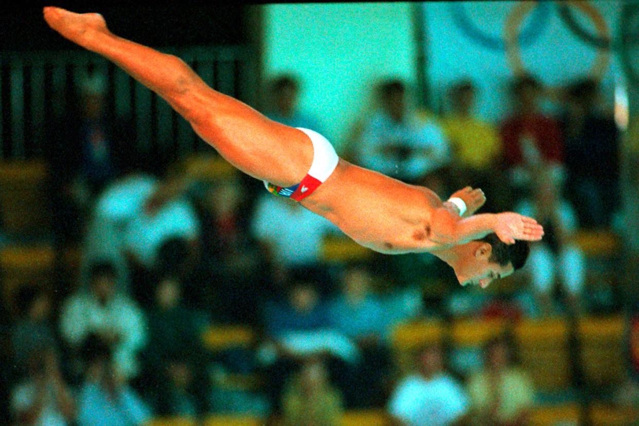 FILE - In this Sept. 26, 1988, file photo, Greg Louganis, of the United States, performs in the men's preliminary 10-meter platform diving competition at the XXIV Summer Olympic Games in Seoul, South Korea.  (AP Photo/Ed Reinke, File)