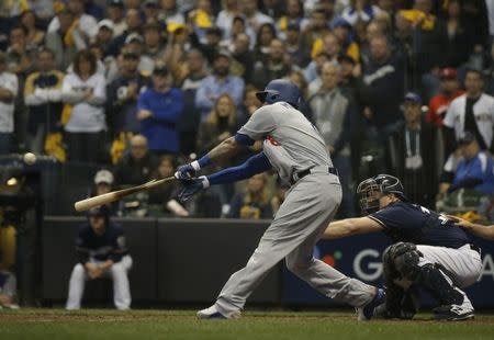 Oct 12, 2018; Milwaukee, WI, USA; Los Angeles Dodgers shortstop Manny Machado (8) hits a 2-RBI single in the eighth inning against the Milwaukee Brewers in game one of the 2018 NLCS playoff baseball series at Miller Park. Mandatory Credit: Jon Durr-USA TODAY Sports