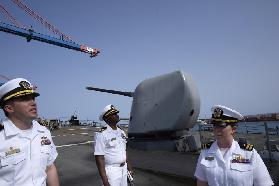 Cmdr. Captain Peter Flynn, left, Cmdr. Executive Officer Tyrchra Bowman, center, and weapons officer Lt. Lindsey Boyle stand on the missile destroyer USS Arleigh Burke, docked in the port in southern city of Limassol, Cyprus, Wednesday, May 17, 2023. (AP Photo/Petros Karadjias)