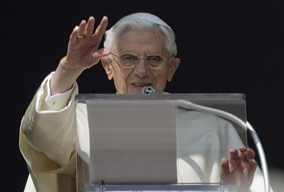 FILE - Pope Benedict XVI acknowledges a cheering crowd during his second to last Angelus prayer from the window of his apartments at the Vatican on Feb. 17, 2013. Pope Emeritus Benedict XVI, the German theologian who will be remembered as the first pope in 600 years to resign, has died, the Vatican announced Saturday. He was 95. (AP Photo/Domenico Stinellis, File)