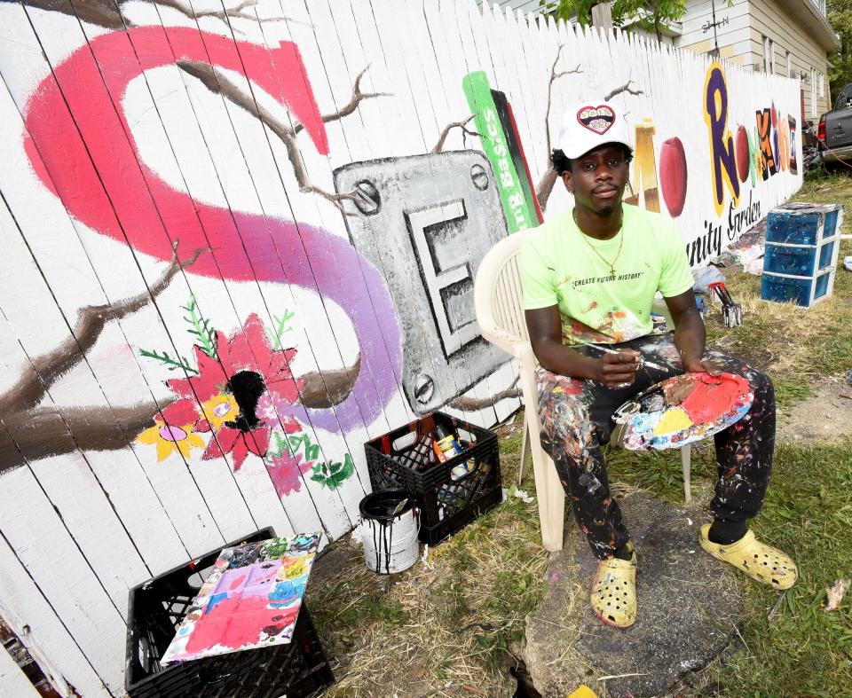 Artist Tony Wavy formerly from Monroe, now living in Lexington, KY has painted the mural on the fencing of the Selma Rankins Community Garden June 11, 2023 as part of the art, culture, community Monroe, Mi Summer 23 plnting seeds program.