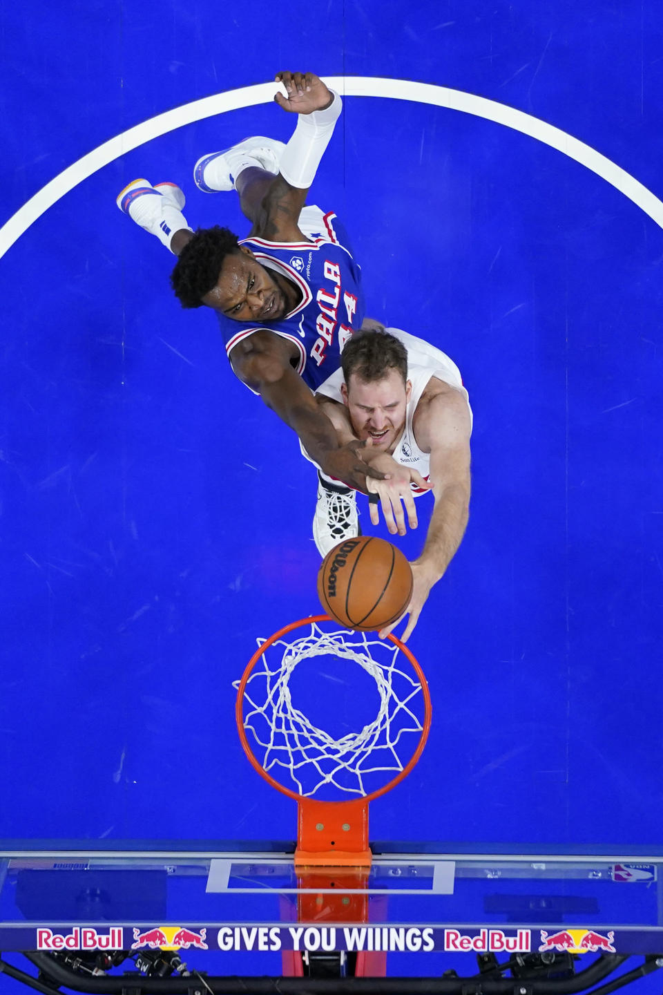 Toronto Raptors' Jakob Poeltl, bottom, tries to dunk against Philadelphia 76ers' Paul Reed during the first half of an NBA basketball game, Thursday, Nov. 2, 2023, in Philadelphia. (AP Photo/Matt Slocum)