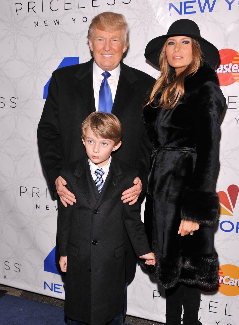 NEW YORK, NY - NOVEMBER 30: Donald Trump (L) and Melania Trump (R) and son Barron (C) attend Rockefeller Center Christmas Tree Lighting Party at Rock Center Cafe on November 30, 2011 in New York City. (Photo by Gary Gershoff/Getty Images for NBC)