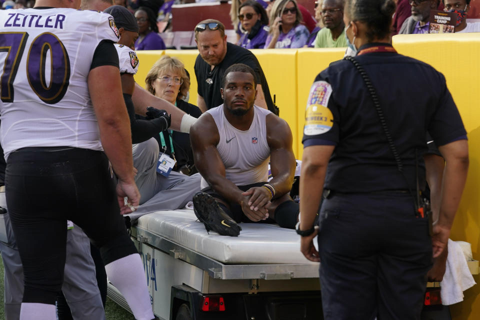 Baltimore Ravens running back J.K. Dobbins (27) is taken off the field after suffering an injury in the first half of a preseason NFL football game against the Washington Football Team, Saturday, Aug. 28, 2021, in Landover, Md. (AP Photo/Carolyn Kaster)