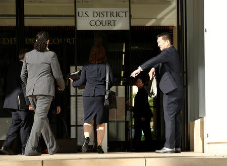 Hawaii Attorney General Douglas Chin (R) arrives at the U.S. District Court Ninth Circuit to present his arguments after filing an amended lawsuit against President Donald Trump's new travel ban in Honolulu, Hawaii, March 15, 2017. REUTERS/Hugh Gentry