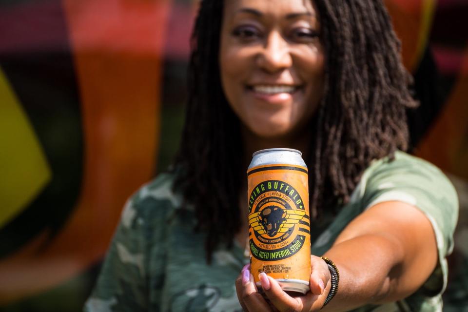 Barb Baker, the 'Siren of Stout,' holds up the Flying Buffalo Screamin' Pumpkin Stout (12% ABV) from Griffin Claw Brewing Co. in Birmingham, Mich.